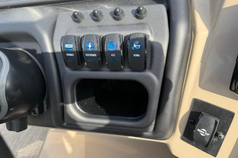 Slide: The Image of Control panel of 2026 Bentley Pontoons Legacy 223 Navigator with labeled switches. - 11