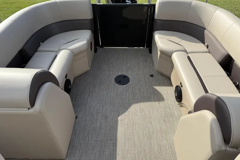 Slide: The Image of 2026 Bentley Pontoons Legacy 223 Navigator interior with beige seating and carpeted floor. - 14