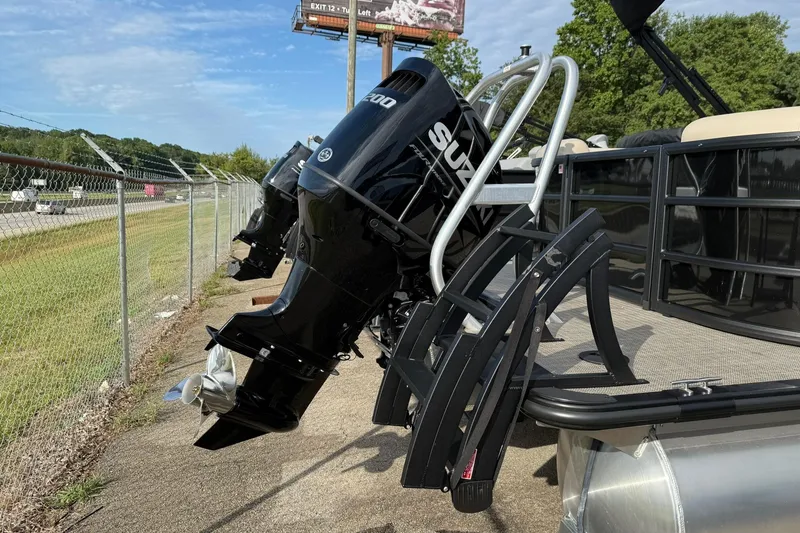 Slide: The Image of 2026 Bentley Pontoons Legacy 223 Navigator with Suzuki outboard motor, docked outdoors. - 6