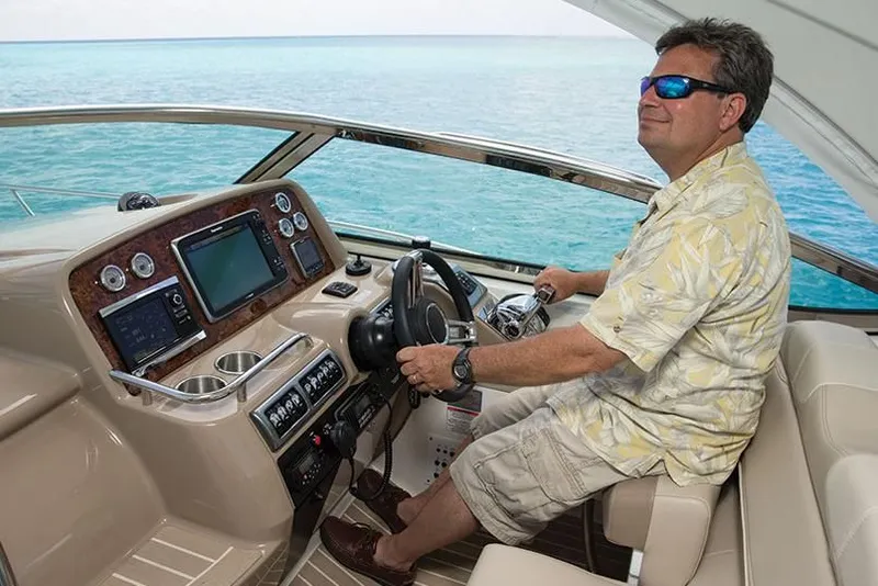 Slide: The Image of Man piloting a 2014 Formula 37 Cruiser yacht on open water. - 57