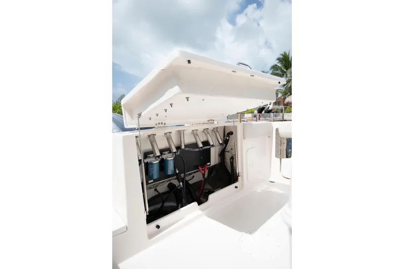 Slide: The Image of 2026 Sailfish 272 CC SE boat storage compartment with open hatch, showcasing internal components. - 12