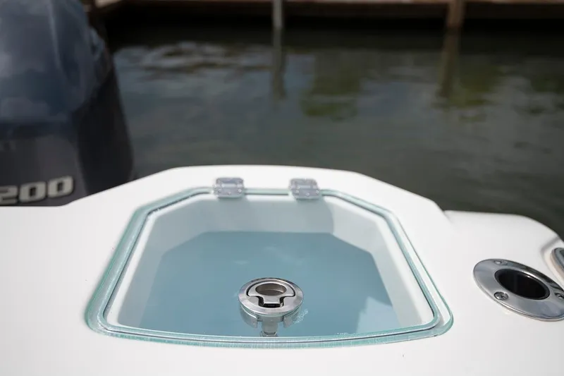 Slide: The Image of Sailfish 272 CC SE 2026 boat with a glass hatch and engine in the background. - 13