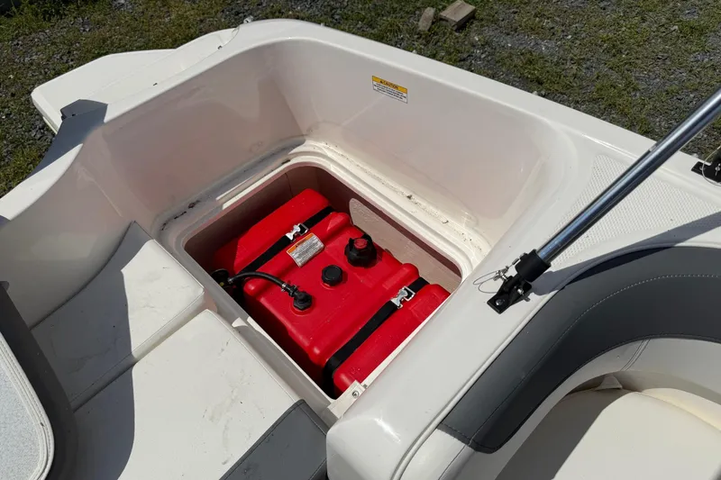Slide: The Image of 2021 Bayliner Element E16 boat storage compartment with red fuel tank. - 12
