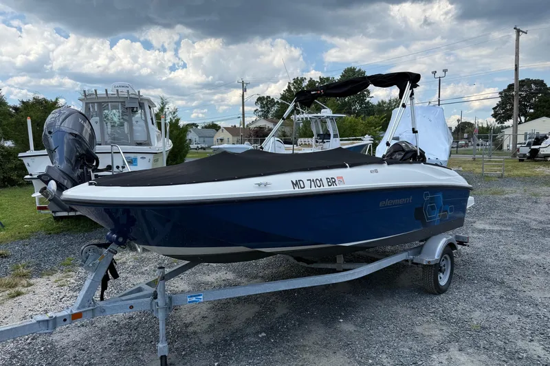 Slide: The Image of 2021 Bayliner Element E16 boat on trailer under cloudy sky. - 13