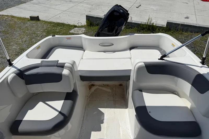 Slide: The Image of 2021 Bayliner Element E16 boat interior with cushioned seating and open deck layout. - 5