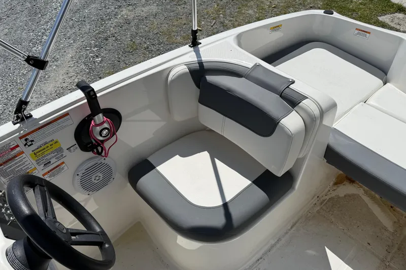 Slide: The Image of 2021 Bayliner Element E16 boat interior with steering wheel and seating. - 6