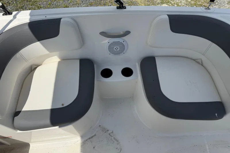 Slide: The Image of 2021 Bayliner Element E16 boat seating area with cup holders and speaker. - 7