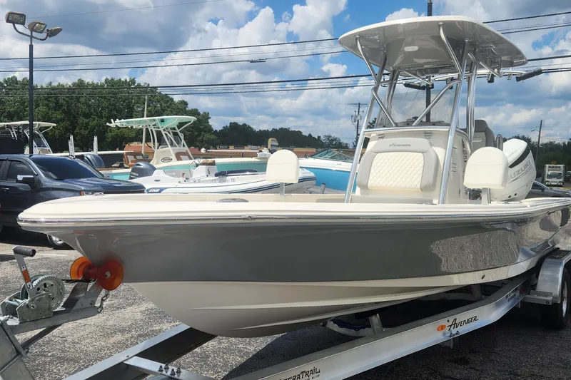 The Image of 2026 Avenger AV26 boat on trailer under cloudy sky at dealership. - 1