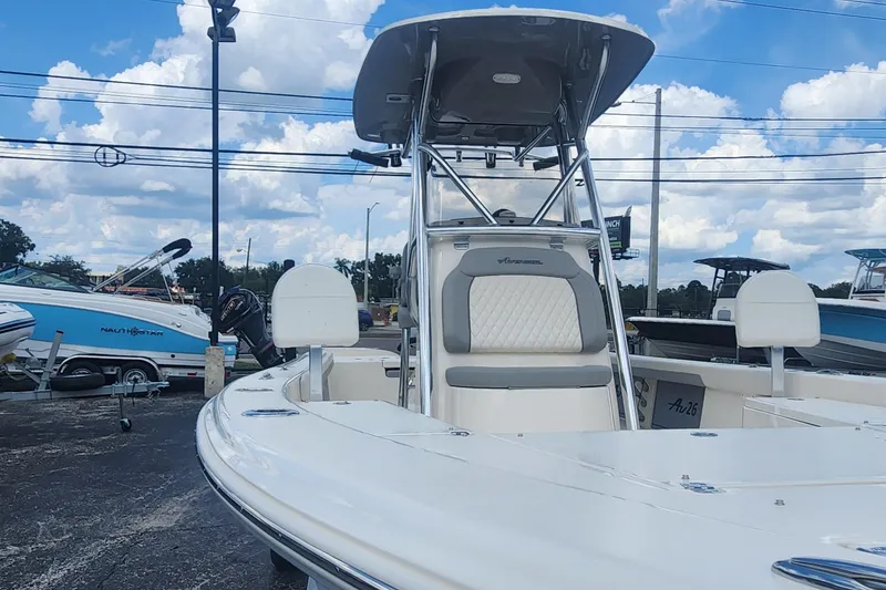 Slide: The Image of 2026 Avenger AV26 boat with sleek design, displayed outdoors under a cloudy sky. - 13