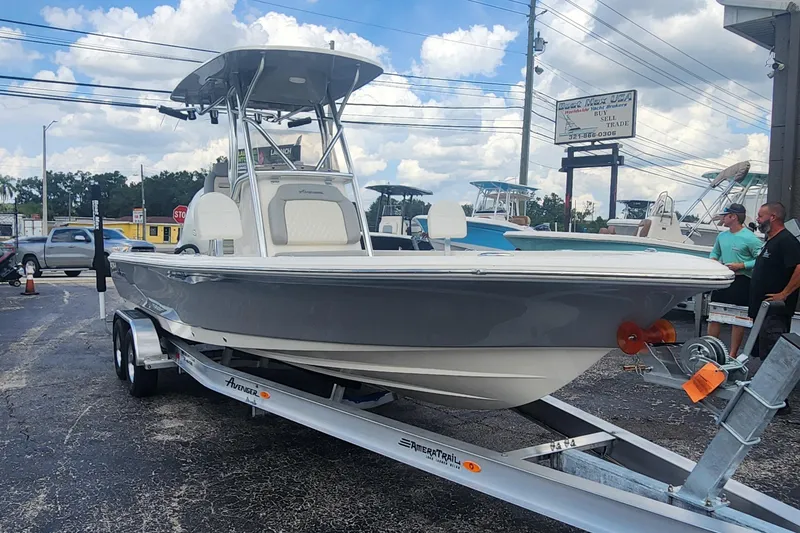 Slide: The Image of 2026 Avenger AV26 boat on trailer, displayed outdoors under a cloudy sky. - 15