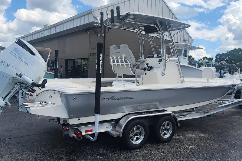 Slide: The Image of 2026 Avenger AV26 boat on trailer with Suzuki outboard motor, parked outdoors. - 4