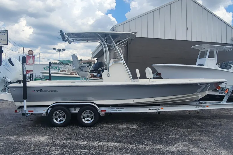 Slide: The Image of 2026 Avenger AV26 boat on trailer, parked outdoors under cloudy sky. - 5