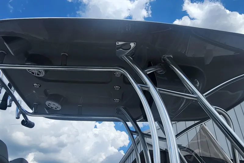 Slide: The Image of Rooftop view of 2026 Avenger AV26 boat with chrome supports against blue sky. - 9