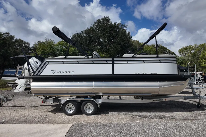The Image of 2026 Viaggio Lago V 20 U pontoon boat on trailer, parked outdoors. - 0