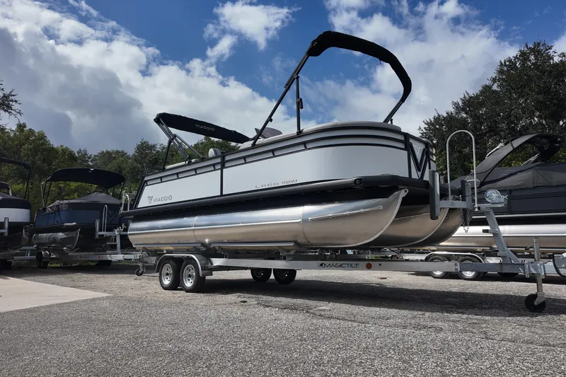 Slide: The Image of 2026 Viaggio Lago V 20 U pontoon boat on trailer under cloudy sky. - 5