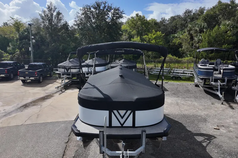 Slide: The Image of 2026 Viaggio Lago V 20 U pontoon boat parked outdoors on a sunny day. - 6
