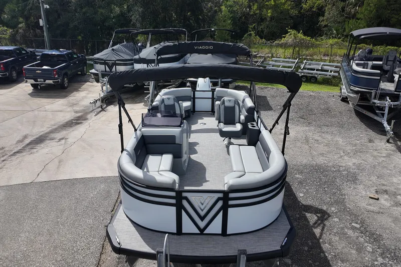 Slide: The Image of 2026 Viaggio Lago V 20 U pontoon boat with spacious seating and canopy in a parking area. - 7