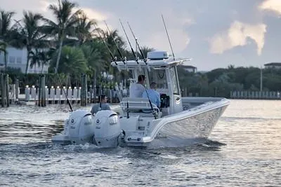 Slide: The Image of 2026 Sailfish 252 CC boat cruising on a calm waterway with fishing rods. - 4