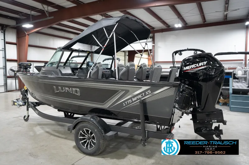Slide: The Image of 2026 Lund 1775 Impact XS boat with Mercury engine in showroom. - 10