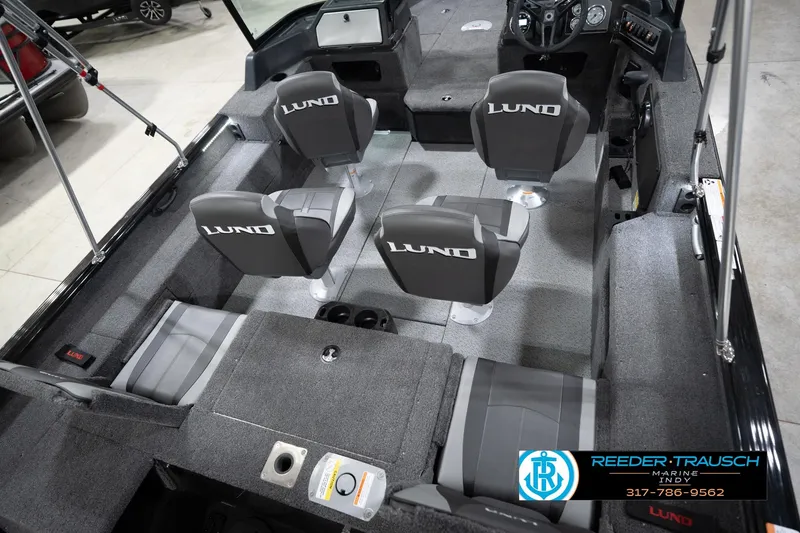 Slide: The Image of 2026 Lund 1775 Impact XS boat interior with four seats and steering console. - 14