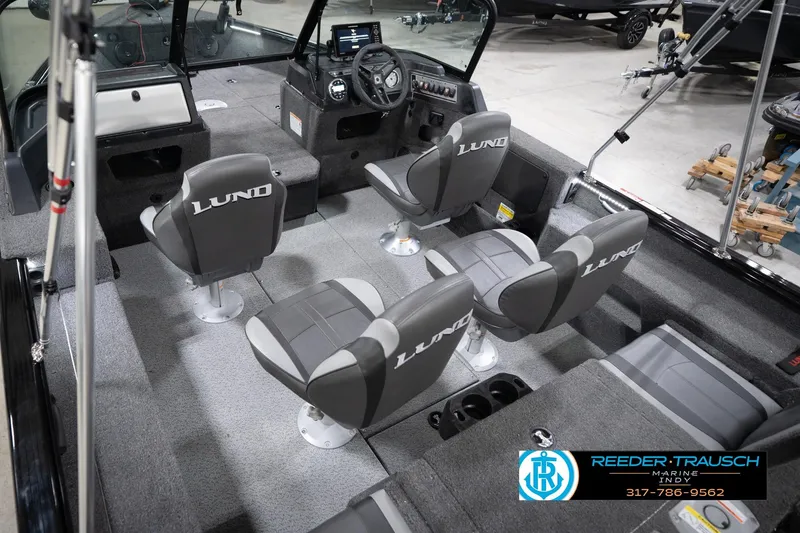 Slide: The Image of 2026 Lund 1775 Impact XS boat interior with four seats and steering console. - 15