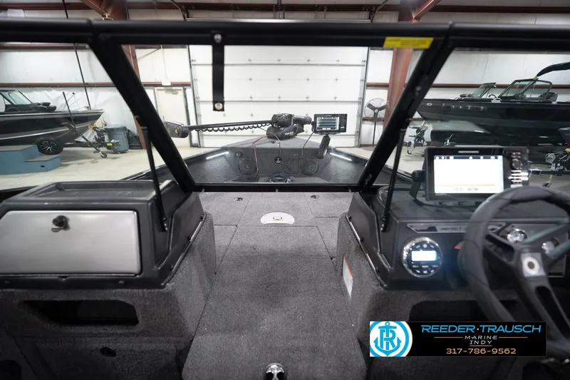 Slide: The Image of 2026 Lund 1775 Impact XS boat interior with modern dashboard and navigation equipment. - 17