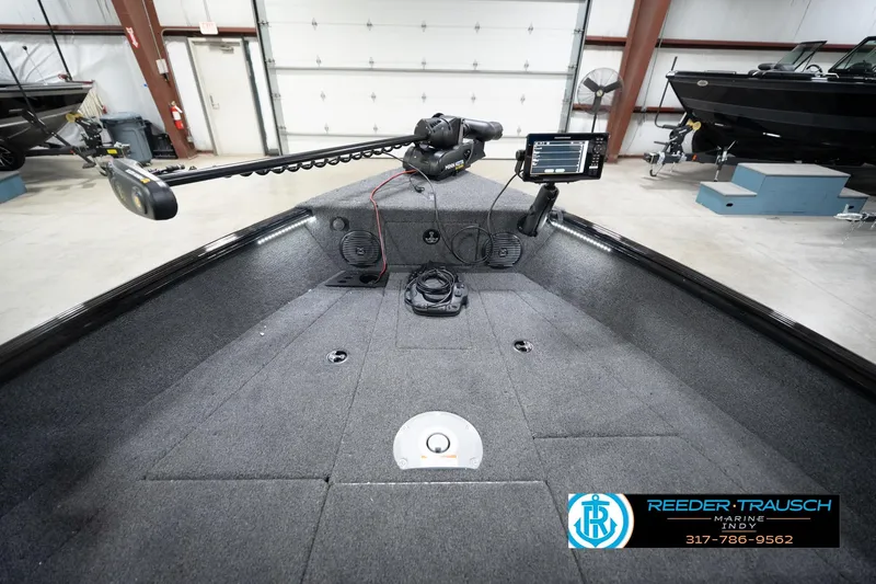 Slide: The Image of 2026 Lund 1775 Impact XS boat interior with fishing equipment in a showroom. - 18