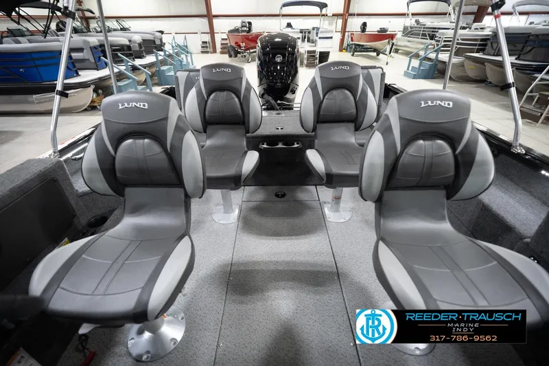 Slide: The Image of 2026 Lund 1775 Impact XS boat interior with four gray seats in a showroom. - 20