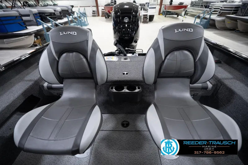 Slide: The Image of 2026 Lund 1775 Impact XS boat interior with two gray seats and a motor. - 21