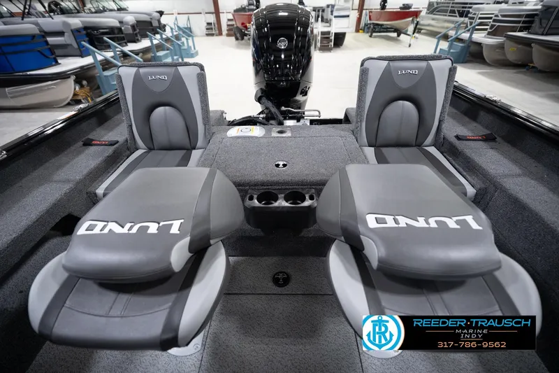 Slide: The Image of 2026 Lund 1775 Impact XS boat interior with gray seating and cup holders. - 22