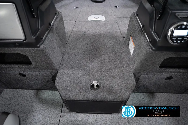 Slide: The Image of Interior of 2026 Lund 1775 Impact XS boat, featuring carpeted flooring and storage compartments. - 31