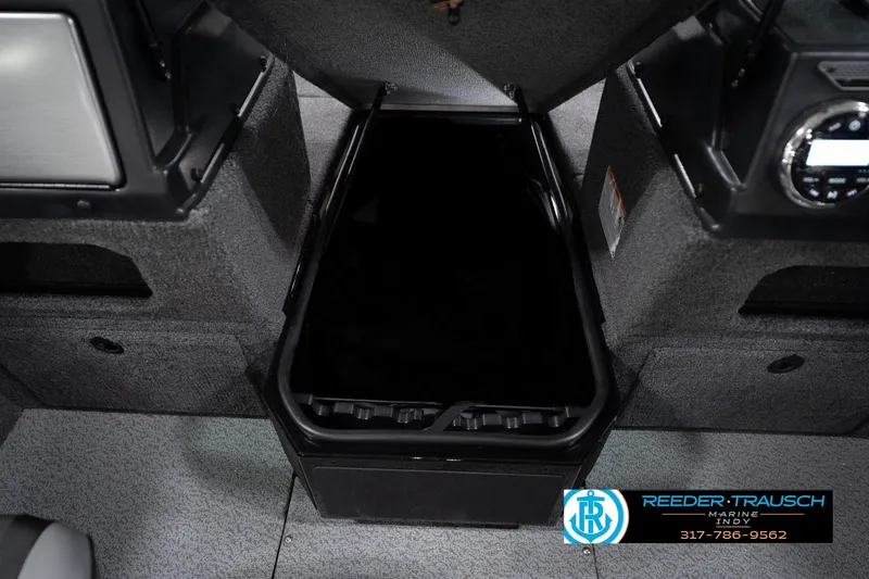 Slide: The Image of Interior storage compartment of 2026 Lund 1775 Impact XS boat, featuring carpeted surfaces. - 32