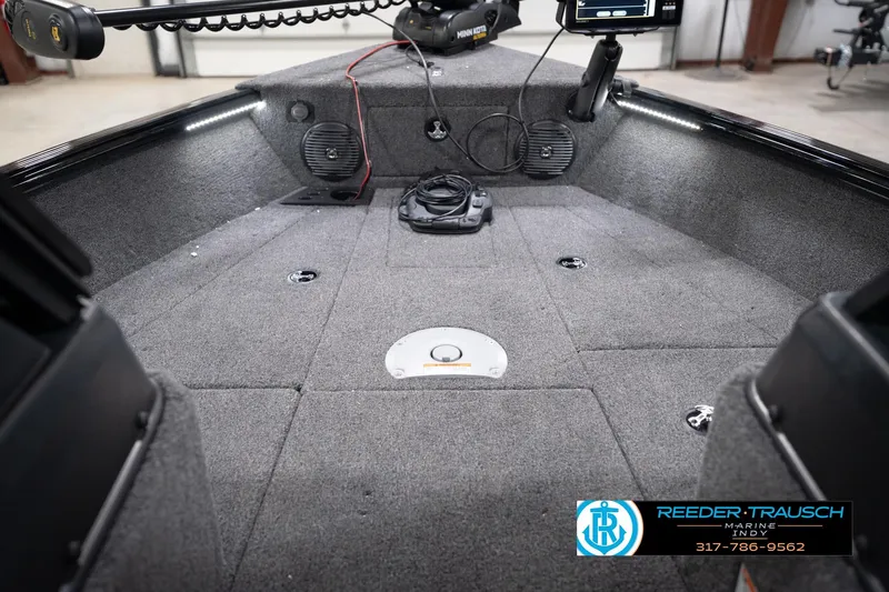 Slide: The Image of Interior of 2026 Lund 1775 Impact XS boat with carpeted deck and fishing equipment. - 33
