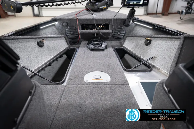 Slide: The Image of 2026 Lund 1775 Impact XS boat interior with storage compartments and electronic equipment. - 34