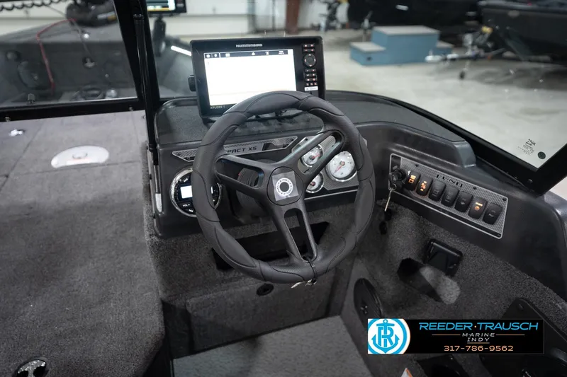 Slide: The Image of 2026 Lund 1775 Impact XS boat dashboard with steering wheel and control panel. - 36