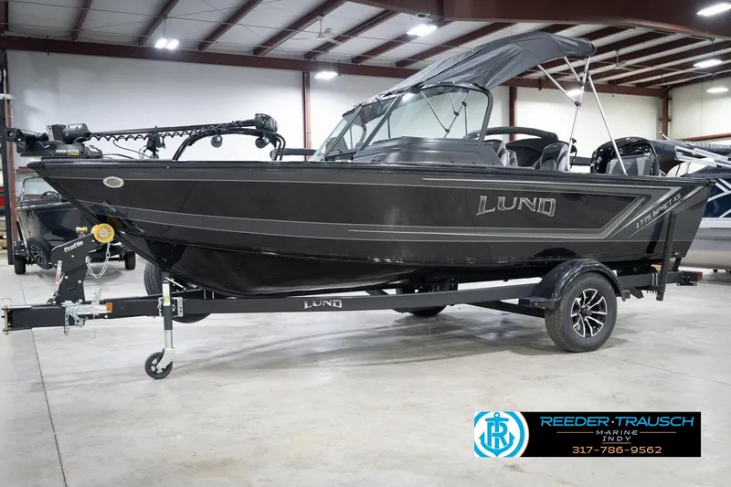 Slide: The Image of 2026 Lund 1775 Impact XS boat on trailer in indoor showroom. - 4