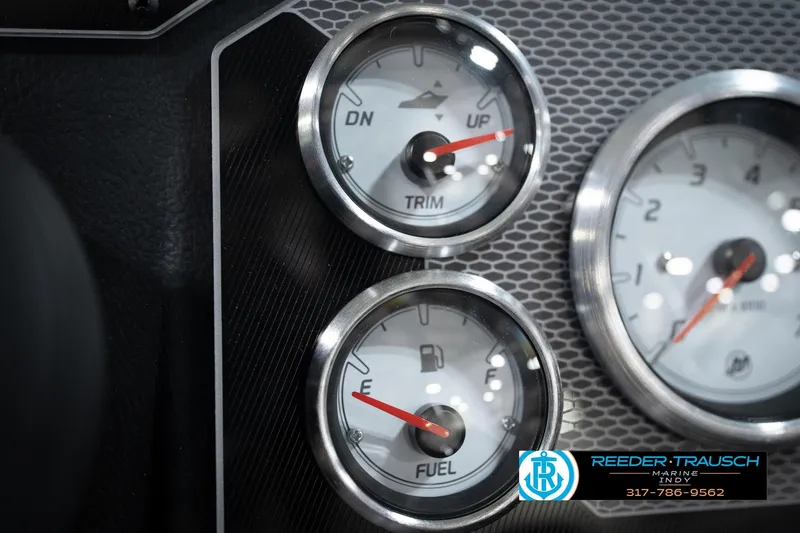 Slide: The Image of 2026 Lund 1775 Impact XS dashboard gauges, featuring trim and fuel indicators. - 40