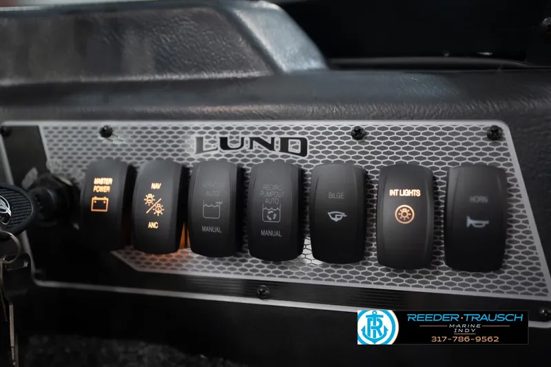 Slide: The Image of Control panel of 2026 Lund 1775 Impact XS boat with illuminated switches. - 42
