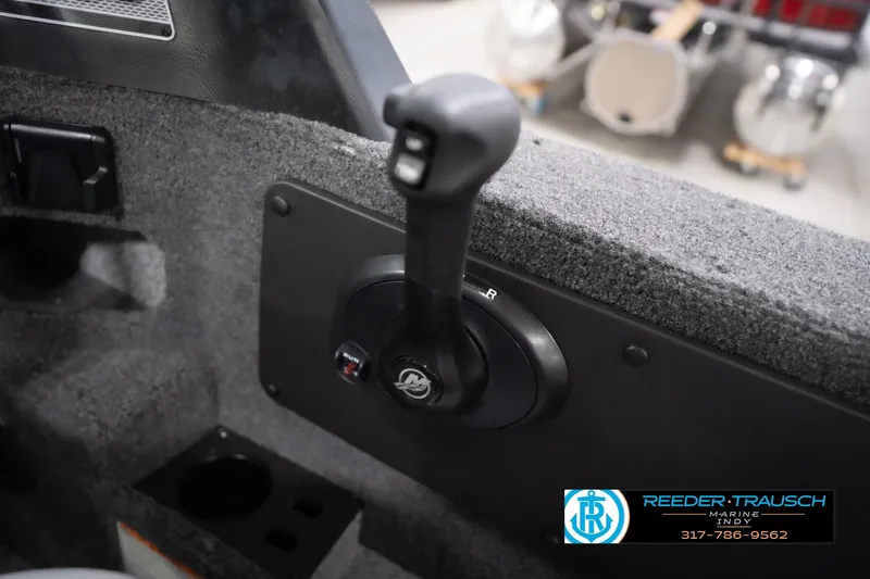 Slide: The Image of 2026 Lund 1775 Impact XS boat throttle control in a carpeted interior. - 44