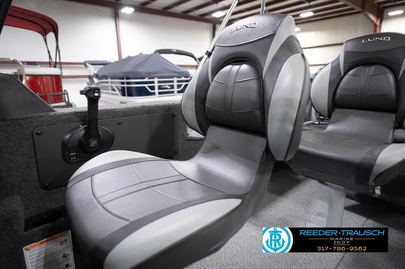 Slide: The Image of 2026 Lund 1775 Impact XS boat interior with gray seats and control lever. - 47