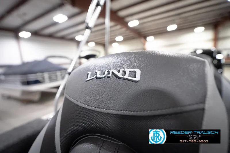 Slide: The Image of 2026 Lund 1775 Impact XS boat seat in showroom with Reeder-Trausch Marine logo. - 48