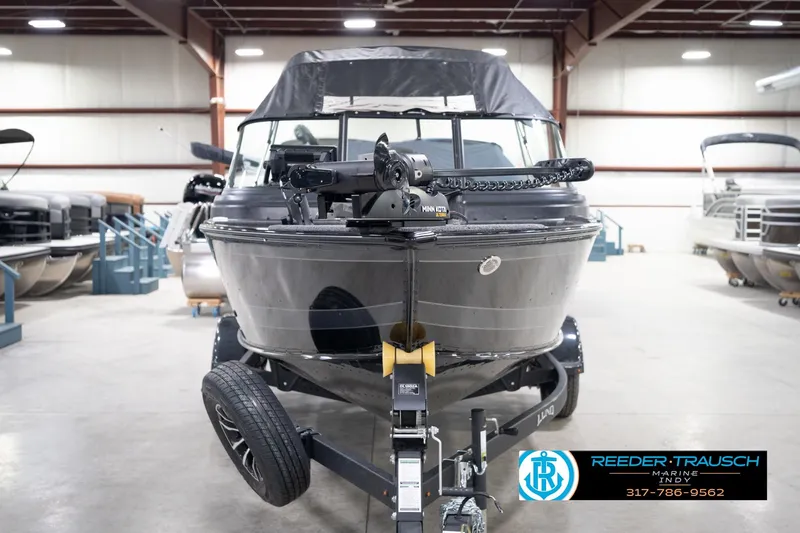 Slide: The Image of 2026 Lund 1775 Impact XS boat on trailer in indoor showroom. - 5