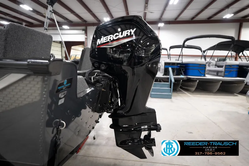 Slide: The Image of 2026 Lund 1775 Impact XS with Mercury outboard motor in showroom. - 52