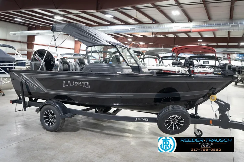 Slide: The Image of 2026 Lund 1775 Impact XS boat on trailer in showroom. - 6