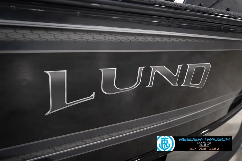 Slide: The Image of 2026 Lund 1775 Impact XS boat side view with logo and dealership details. - 61