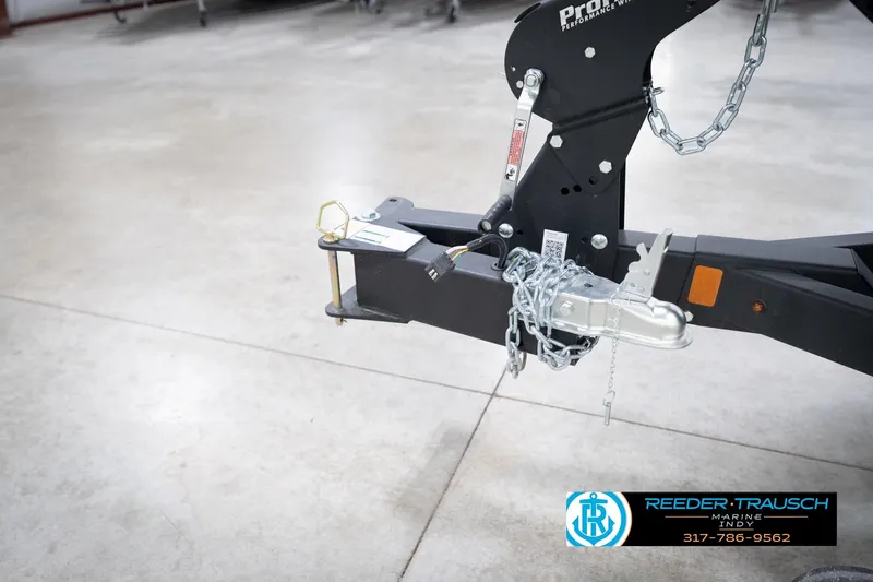 Slide: The Image of Trailer hitch of 2026 Lund 1775 Impact XS with chains and lock mechanism. - 64