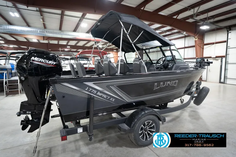 Slide: The Image of 2026 Lund 1775 Impact XS boat with Mercury engine in showroom. - 8