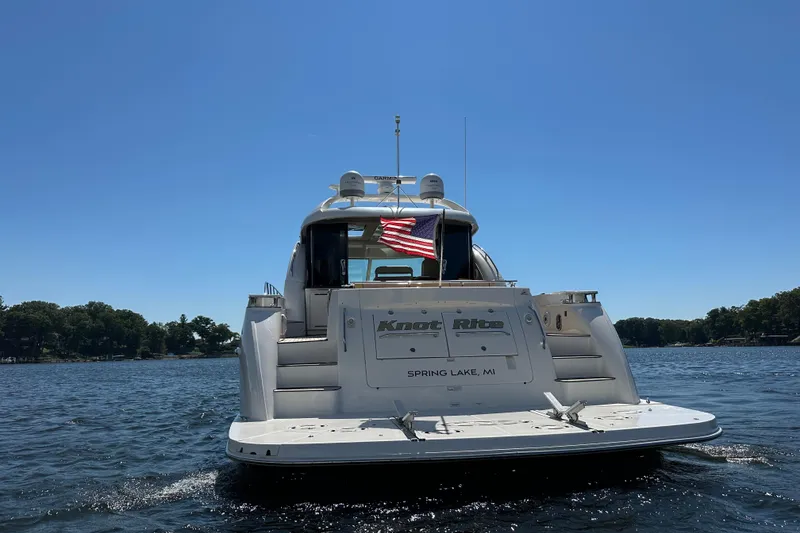 Slide: The Image of 2009 Sea Ray 60 Sundancer yacht on water, American flag, sunny day. - 2