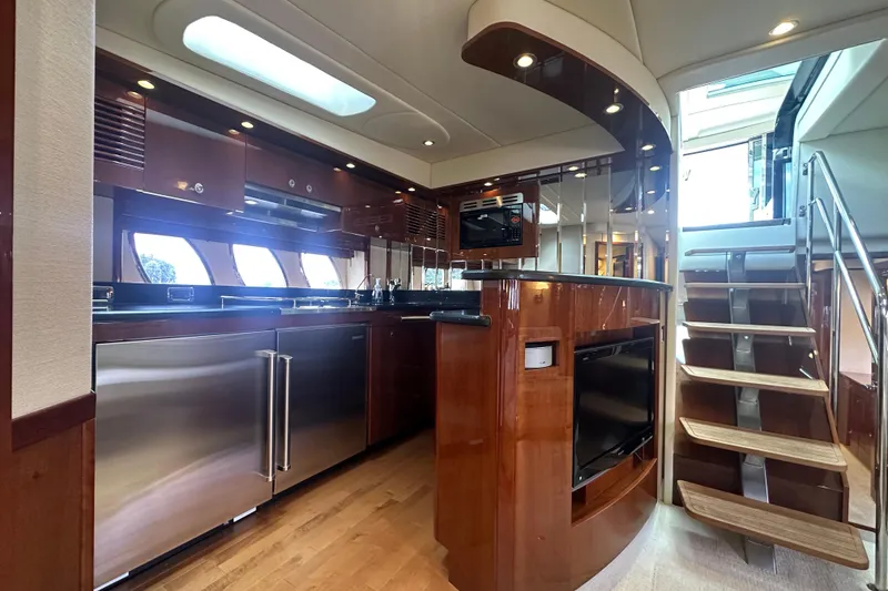 Slide: The Image of Luxurious interior of 2009 Sea Ray 60 Sundancer yacht with modern kitchen and staircase. - 20