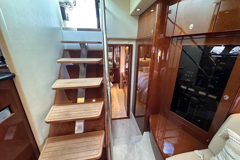 Slide: The Image of 2009 Sea Ray 60 Sundancer interior with wooden stairs and luxurious cabin view. - 24